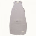 Grey and whte striped baby sleeping bag without sleeves and a double zip on the side against a white background
