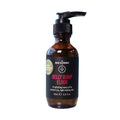 An amber pump bottle of Belly Bump Elixir by The Nude Alchemist, featuring a black label with red and white text, set against a plain white background.