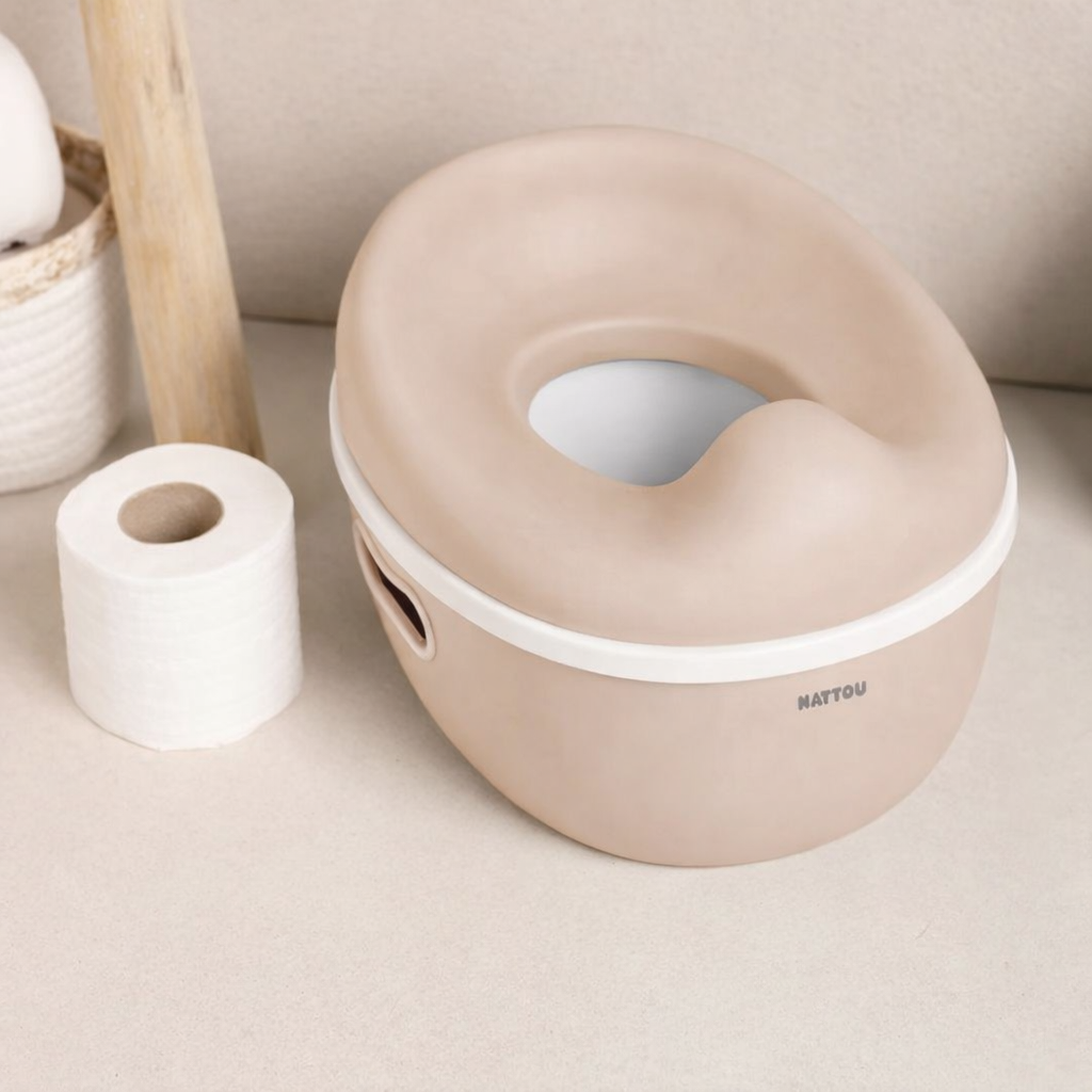 Clay coloured baby potty with white rim on a neutral background