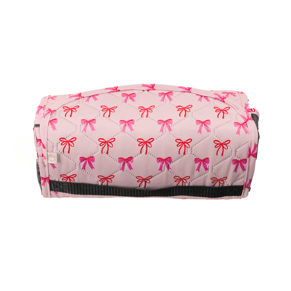 Bow print waterproof kids play mat folded up on white background