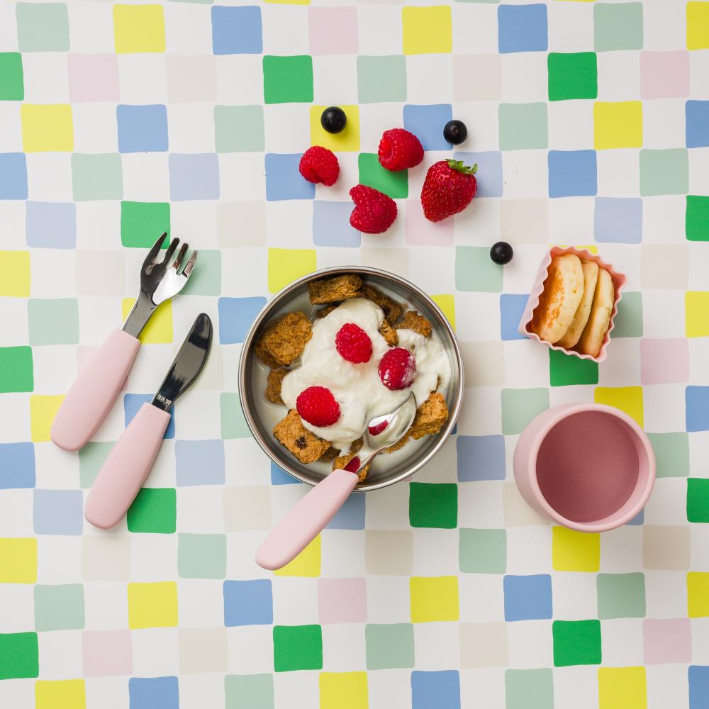 Table setting with toddler food using Nestling suction bowl and stainless steel cutlery