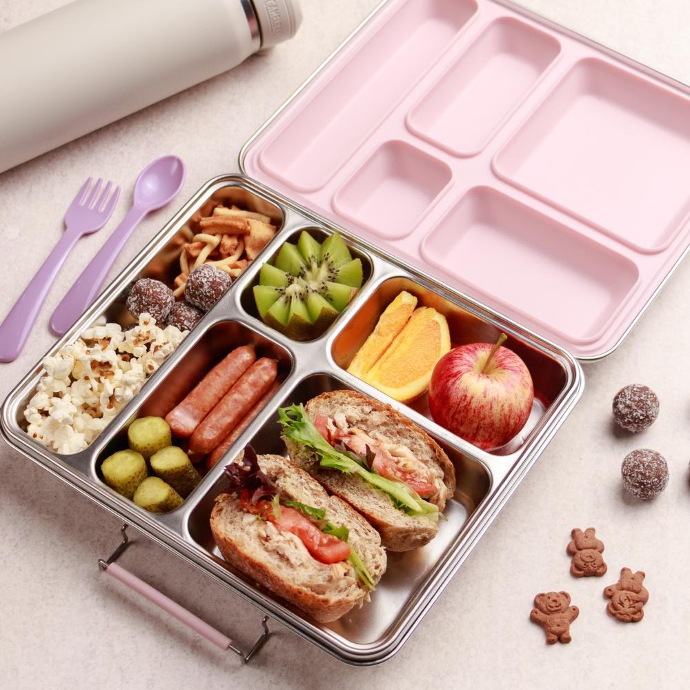 Nestling Jumbo stainless steel bento Divided lunch container with various food items on a light surface