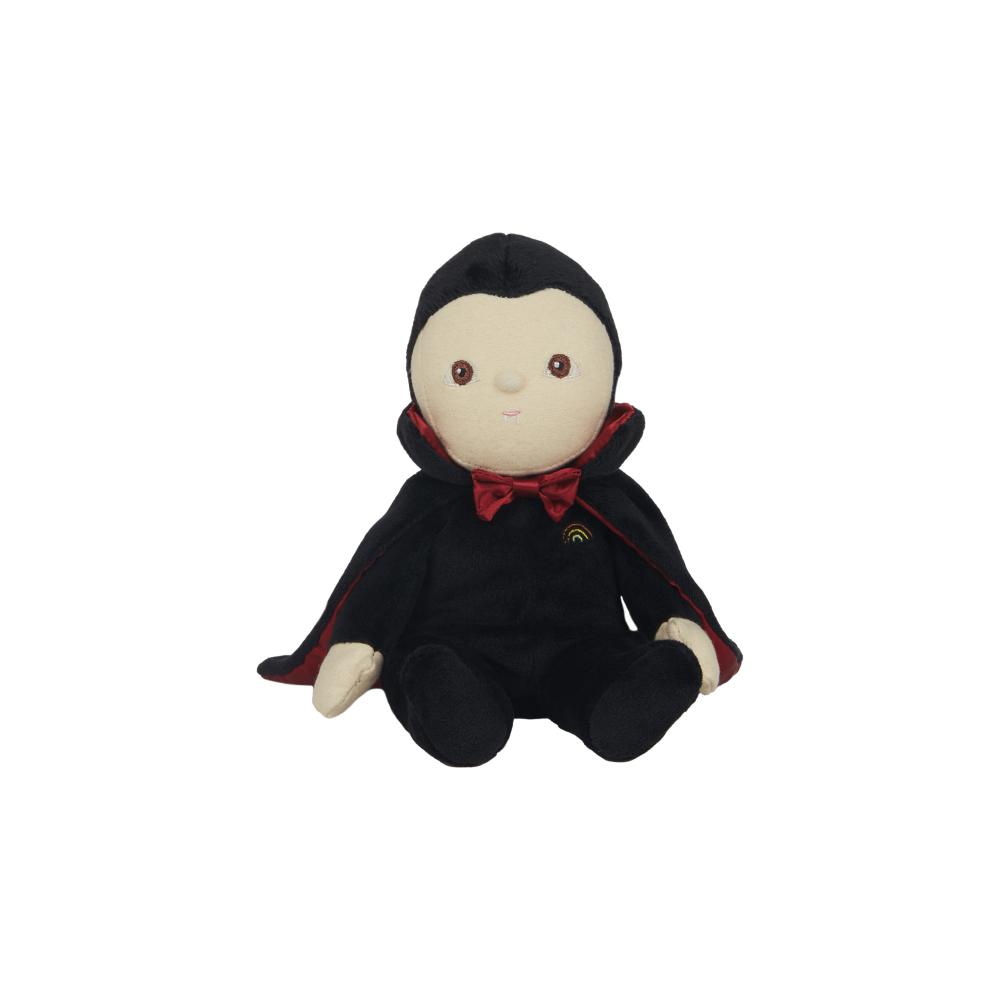 A small plush vampire doll with a black hooded cape, cream-colored face and hands, and a red bow tie, seated against a plain white background.