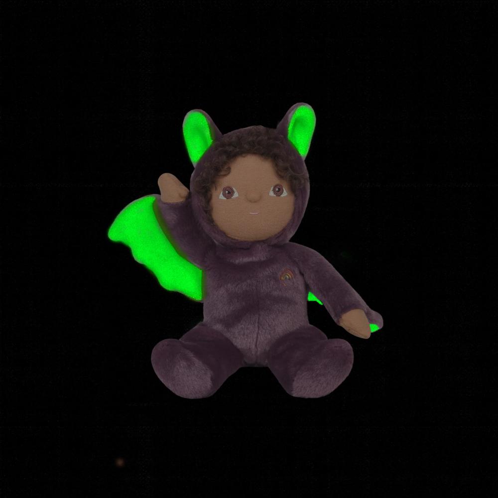 Plush toy in a dark purple costume with green wings on a black background
