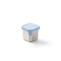 Small storage container with a blue lid on a white background