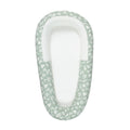 Green print baby nest with mesh base with floral pattern on a white background