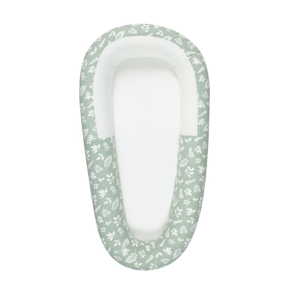 Green print baby nest with mesh base with floral pattern on a white background
