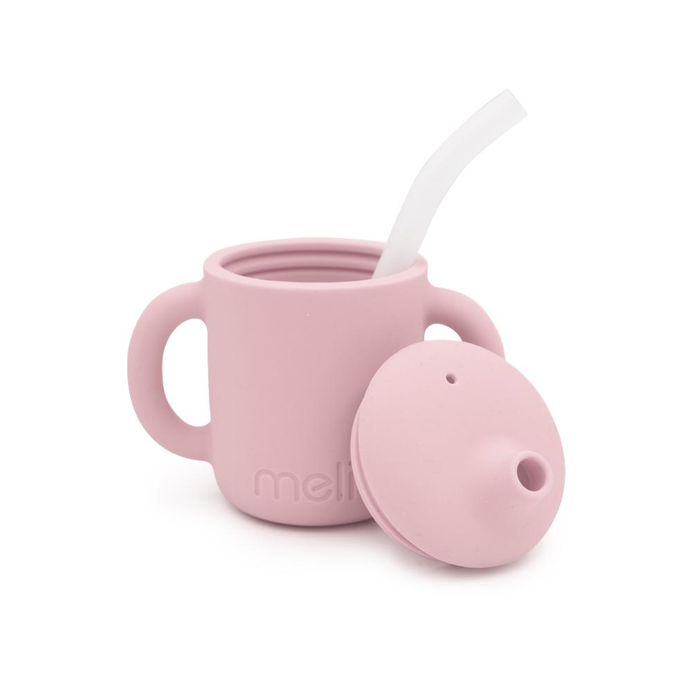 Pink silicone cup with lid and straw on a white background