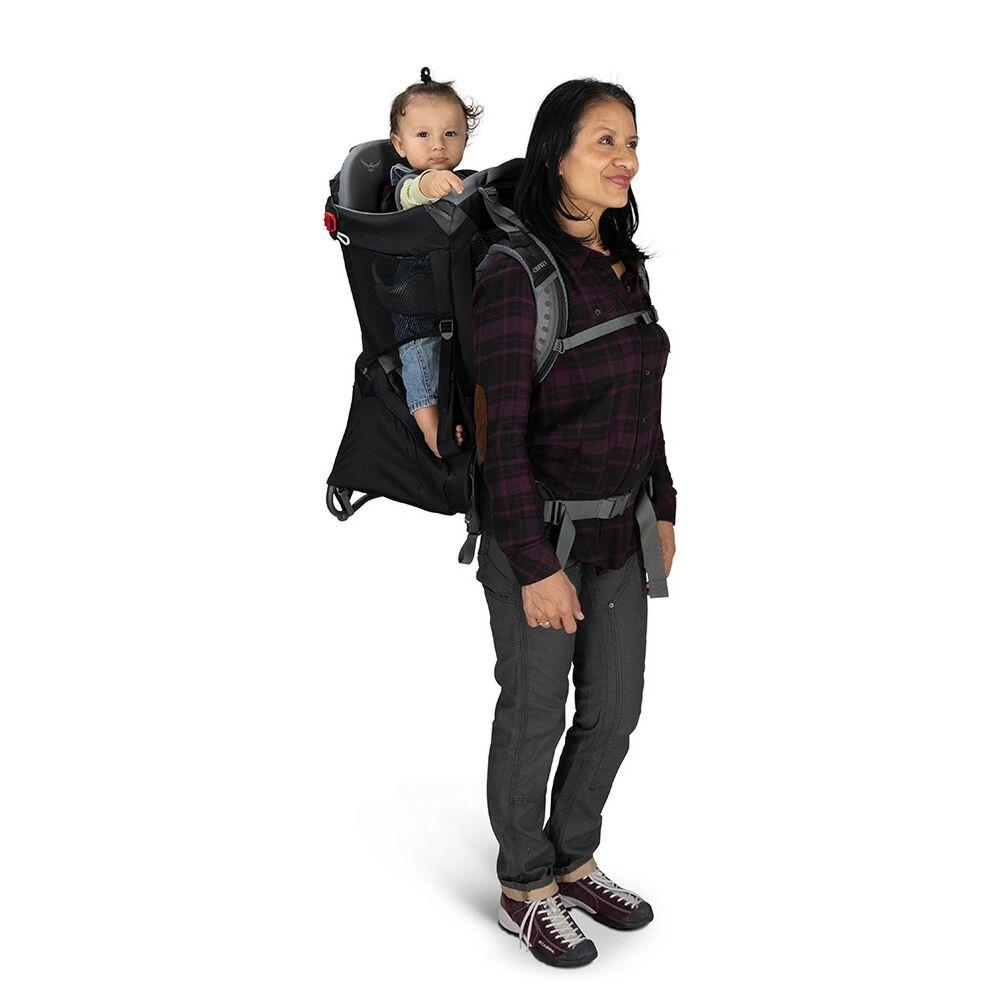 A woman wearing a Osprey Poco Child Carrier with a toddler inside. 