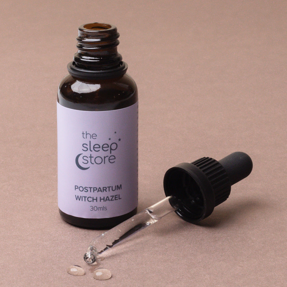 Bottle of postpartum witch hazel from The Sleep Store on a beige background