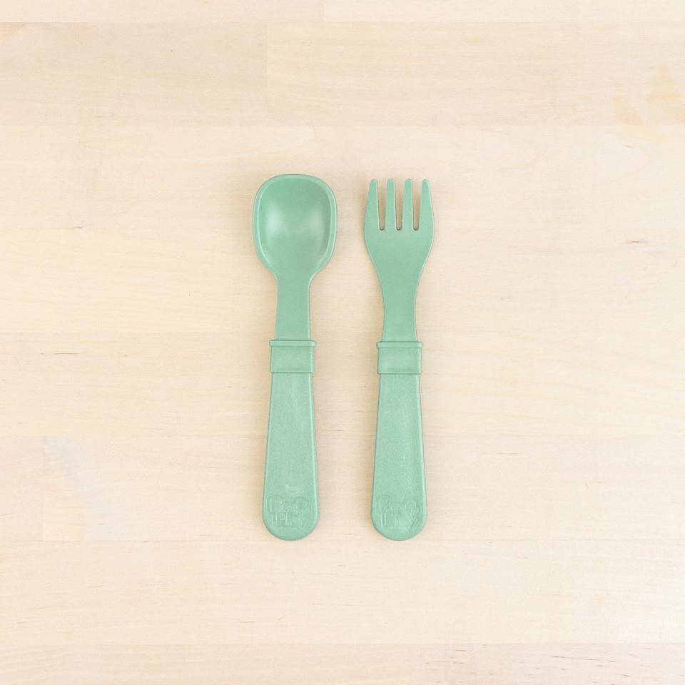 A Re-Play Fork and Spoon - Sage on a white background
