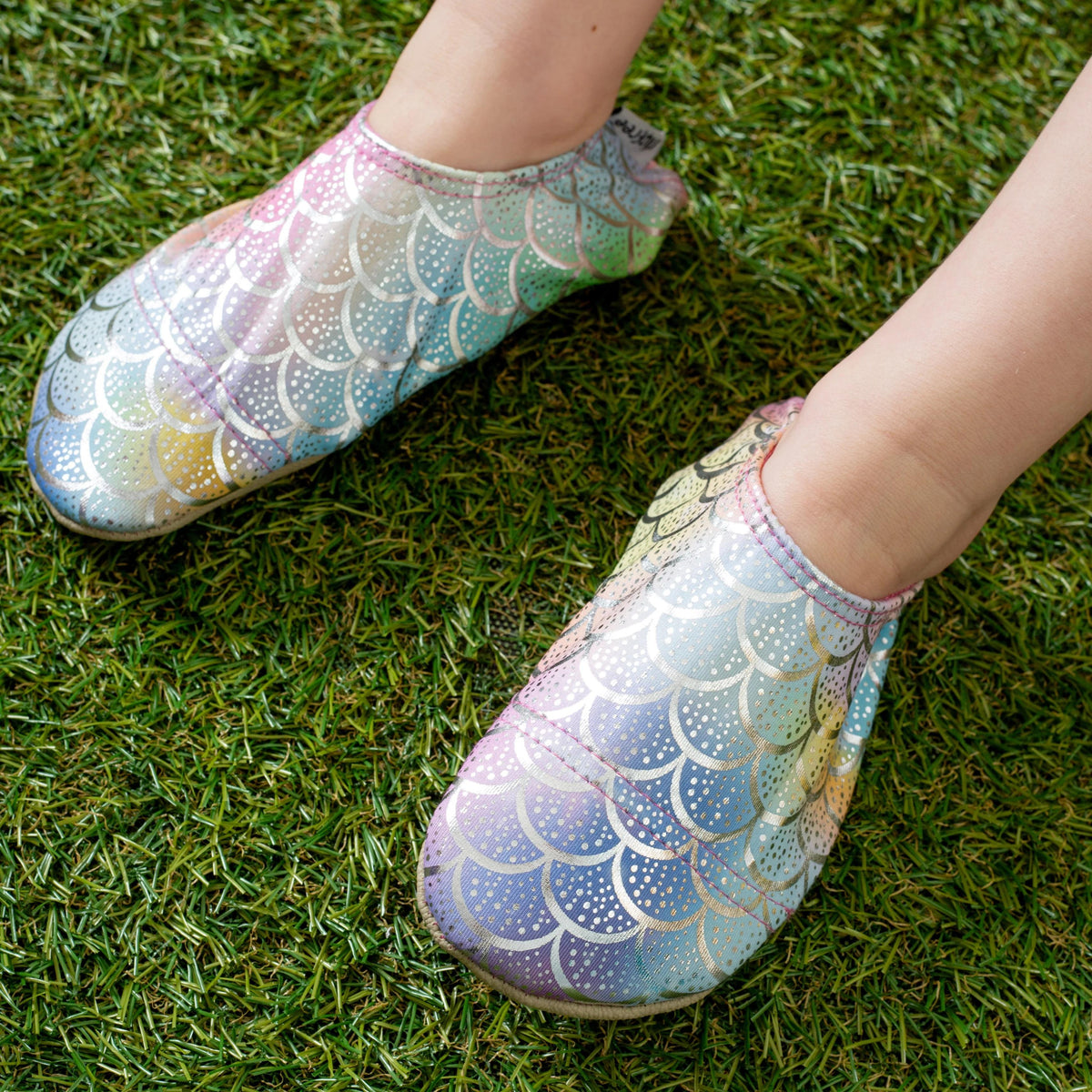 Colorful mermaid scale-patterned slipfree water shoes on a grassy surface