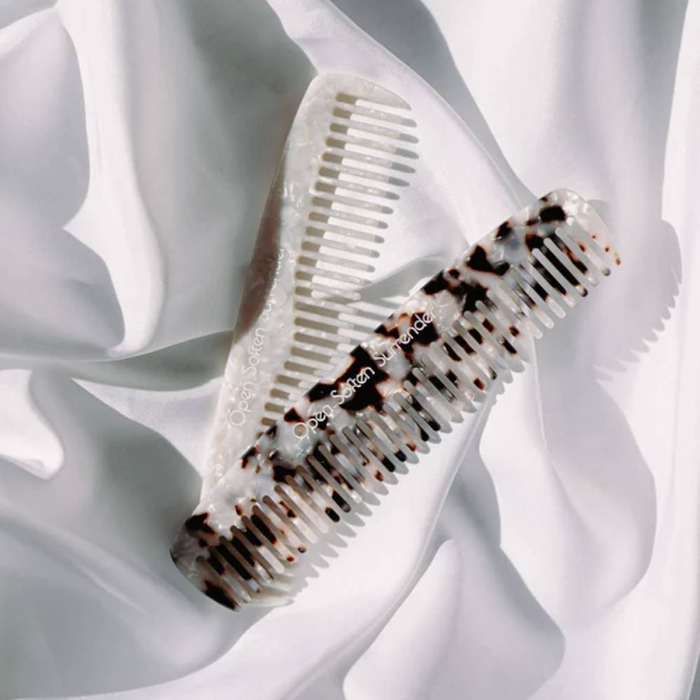 Seasons Of Mama birth combs against white fabric background.
