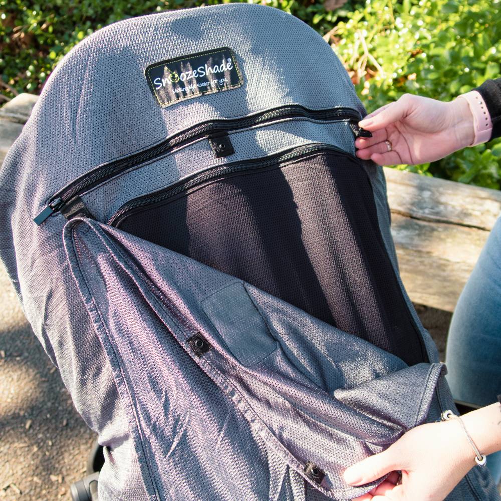 Person adjusting a Snoozeshade buggy cover.