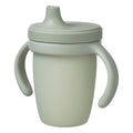 Green sippy cup with handles on a white background