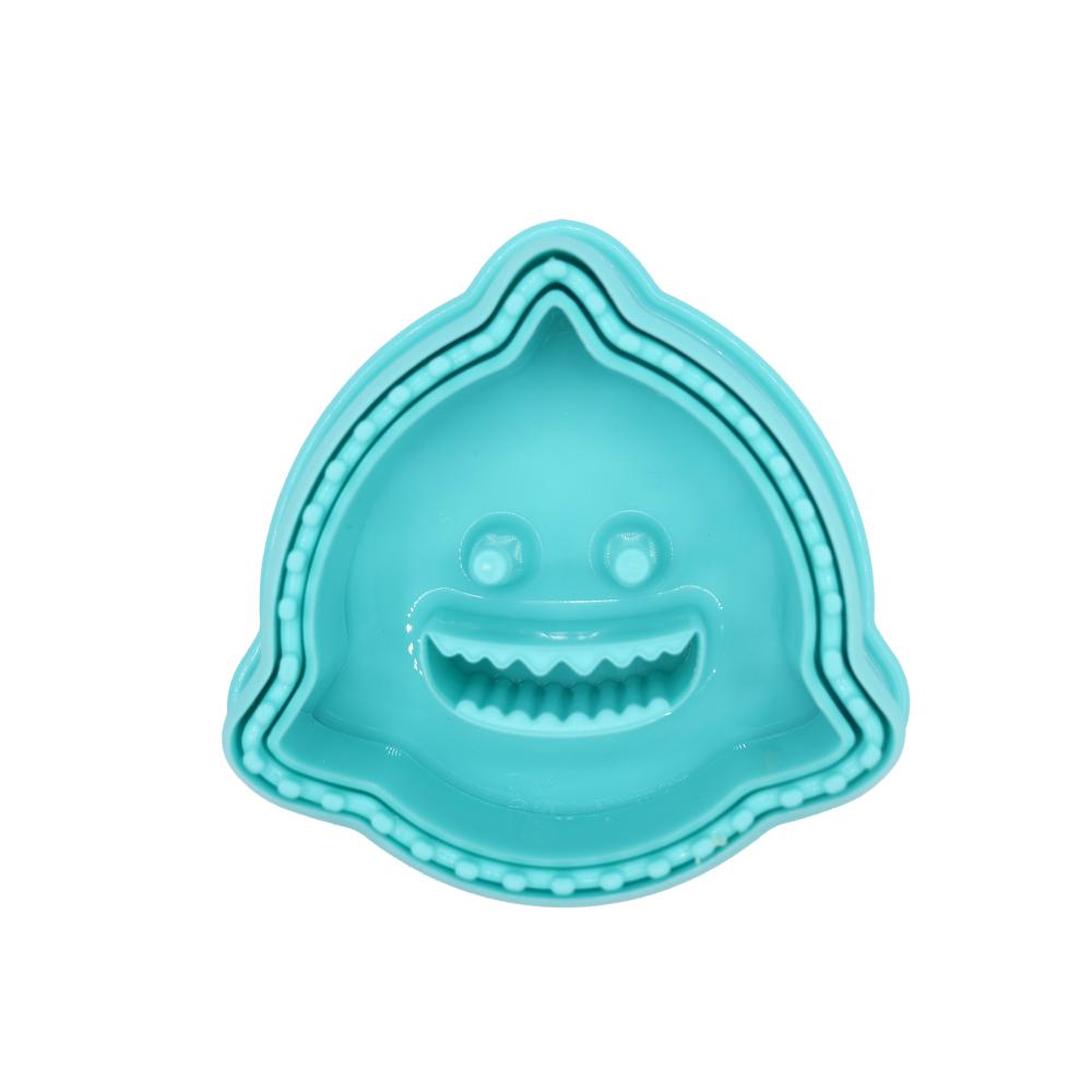 Stack of turquoise ceramic bowls with a smiley face design on a white background
