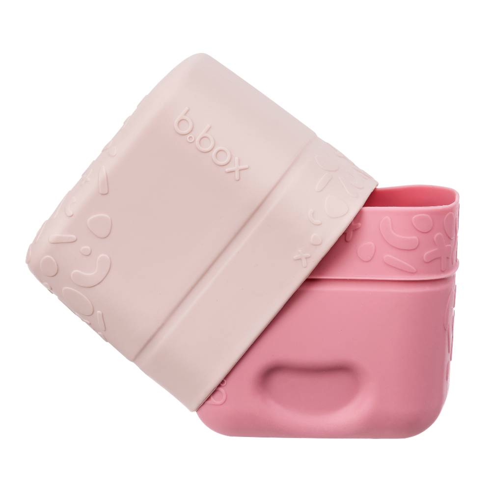 Pink b.box snack container with lid on a white background