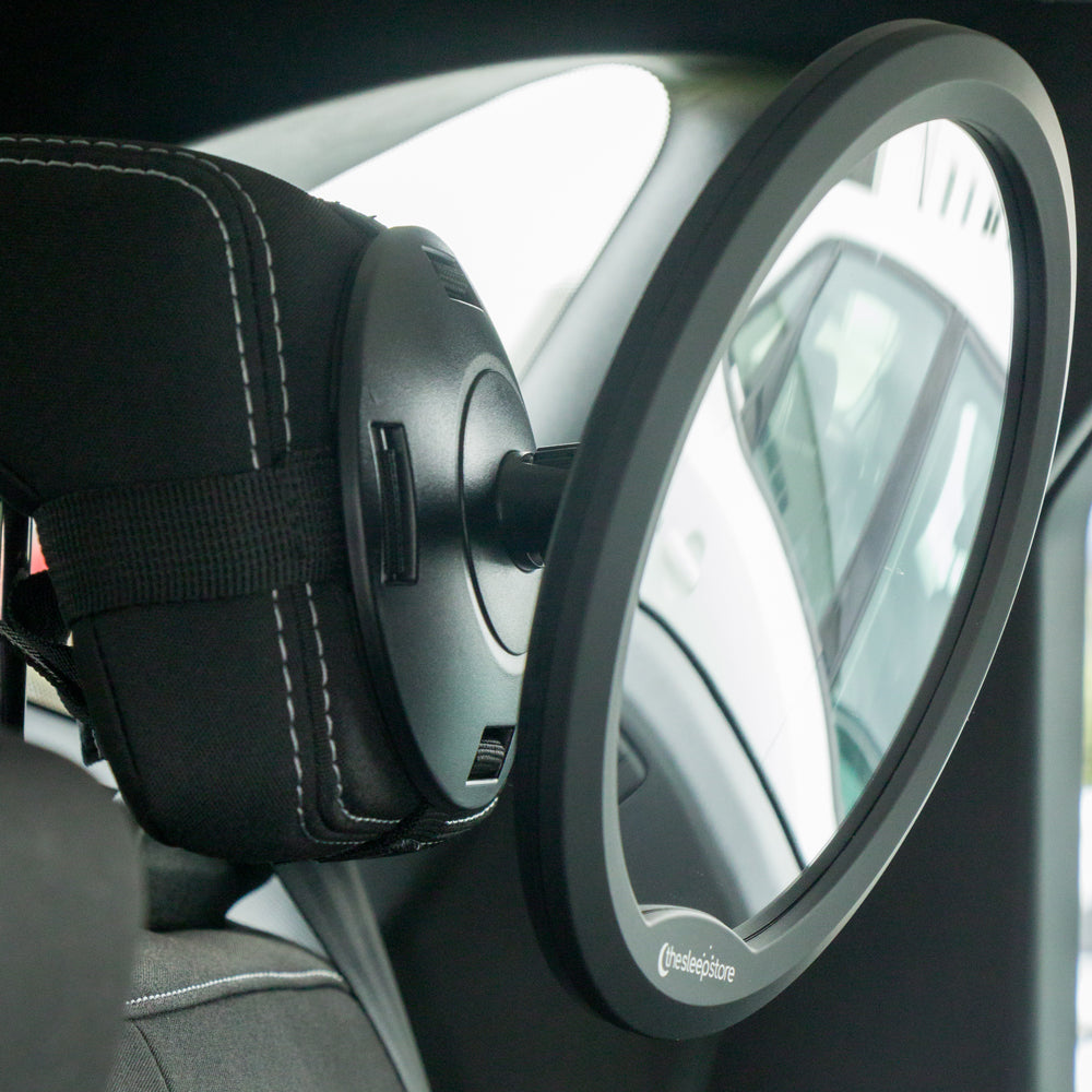 Car mirror attached to a car's interior, showing a clear view of the road.