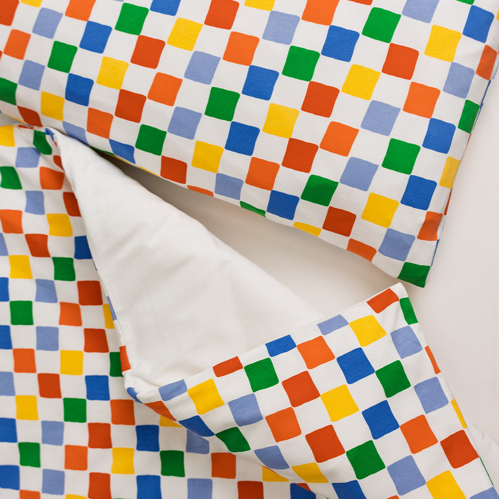 Matching Cotton duvet cover and pillowcase in a bright colour check print.