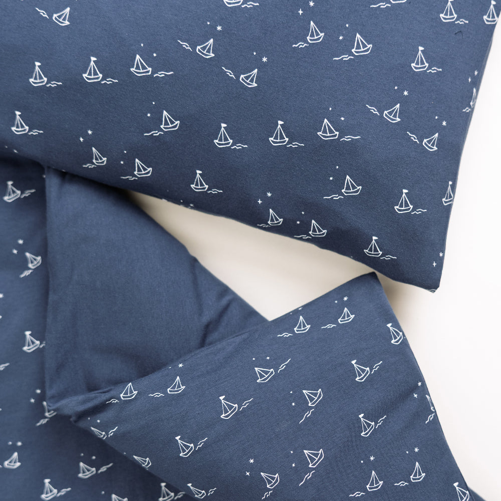 Matching duvet cover and pillowcase. Navy with an all over sailboat print.