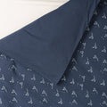 Cotton duvet cover with a navy background and all over sailboat print on one side and solid navy colour on the other side. 