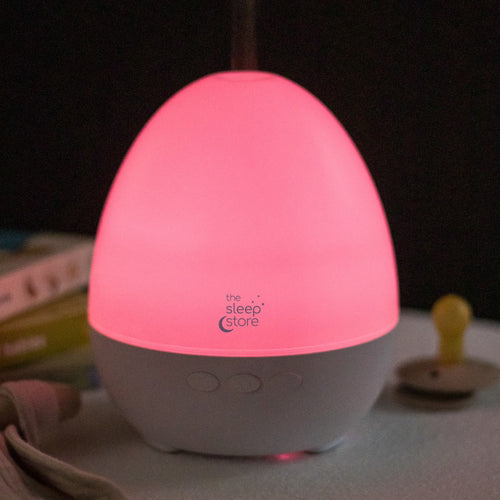 The Sleep Store branded aroma diffuser shown with a red nightlight glow and dark background
