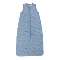 A sleeveless cotton baby sleep sack with blue whales on a blue background, shown flat against a white background.