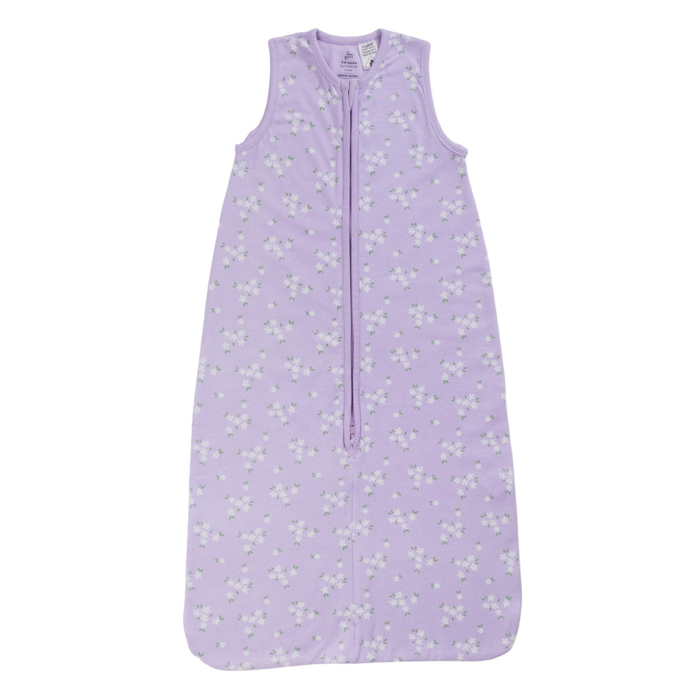 A sleeveless cotton baby sleep sack with a floral print on a lilac background, shown flat against a white background.