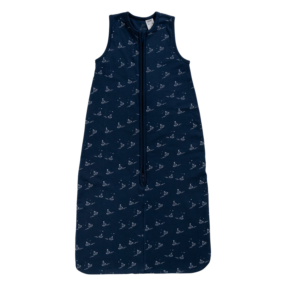 A sleeveless cotton baby sleep sack with a navy sailboat print shown flat against a white background.