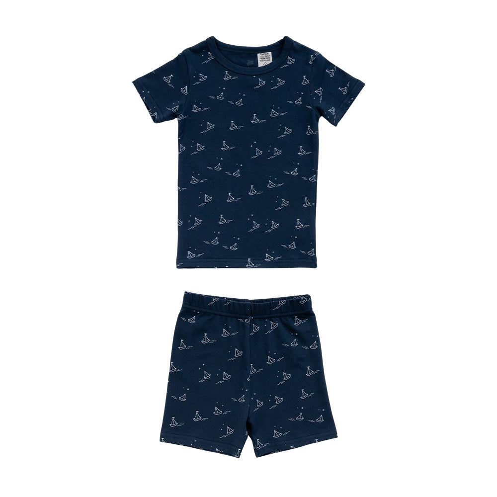 Cotton summer Pjs on a navy base with an all over sailboat print on a white background. 