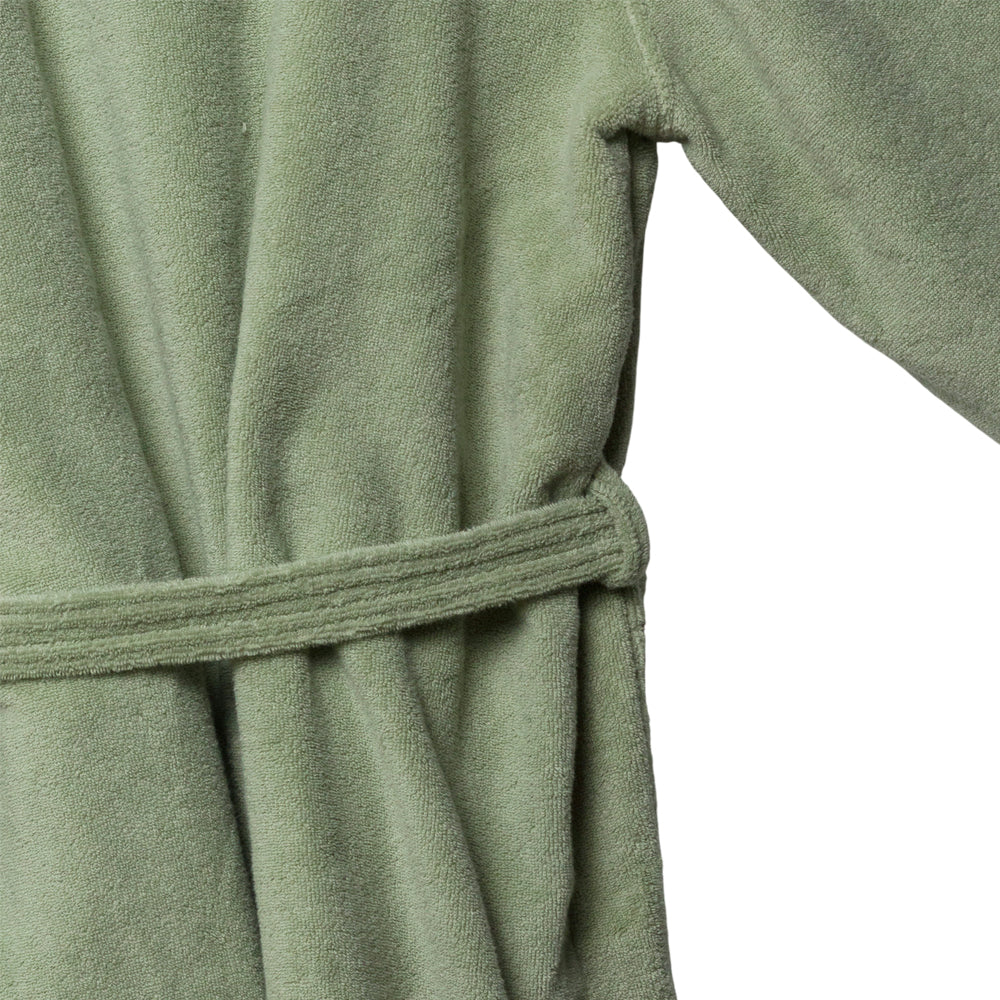 Close-up of a green towelling robe with a belt on a white background