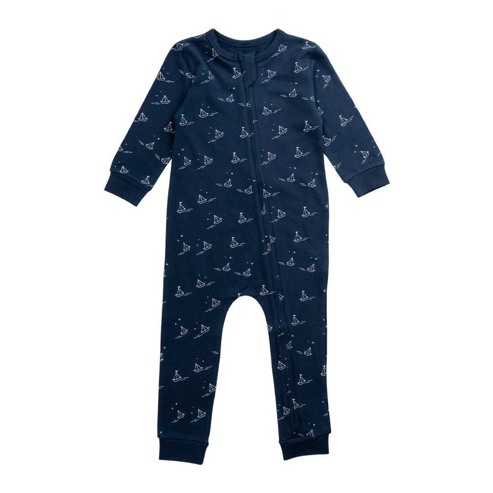Cotton Zipsuit with a navy base and an all over sailboat print on a white background. 