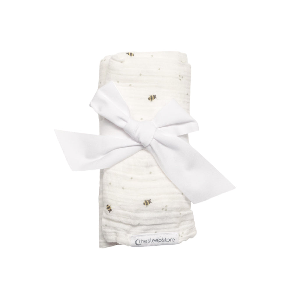 Prem sized NICU muslin wrap with bee print with a bow on a white background