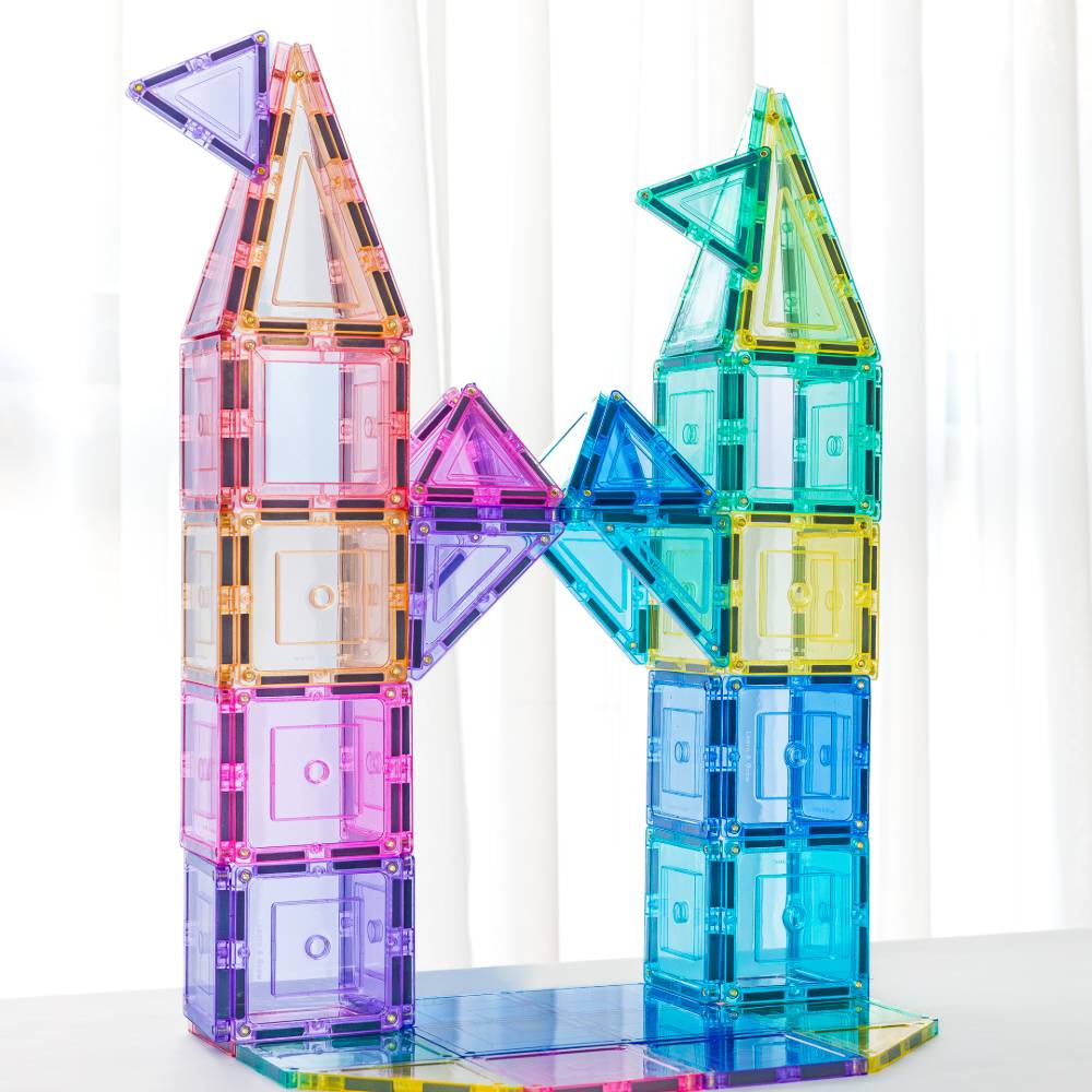 Colorful magnetic tiles stacked into a tower on a white background