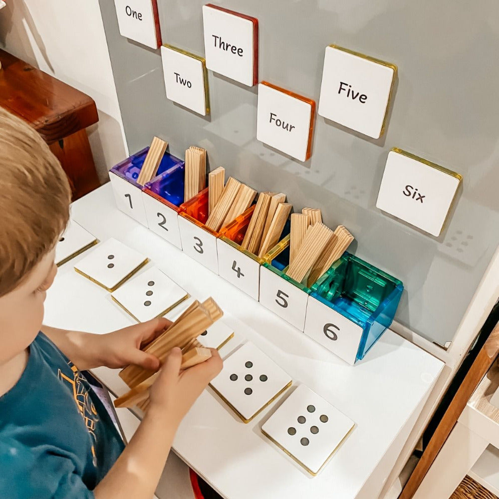 A boy playing with blocks and tile tek toppers.