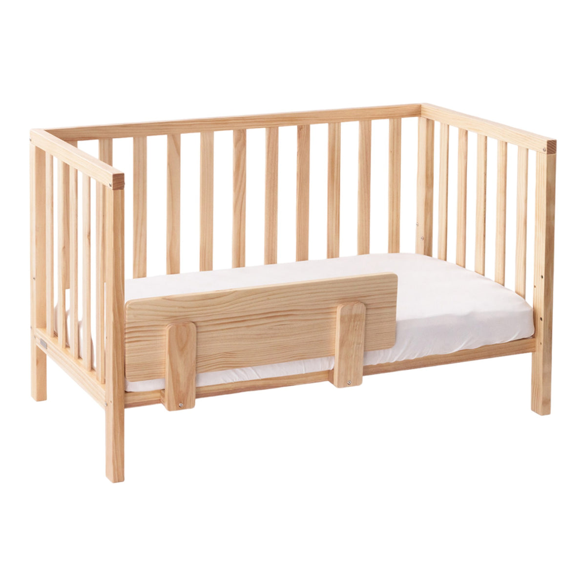 Wooden crib with a white mattress on a white background