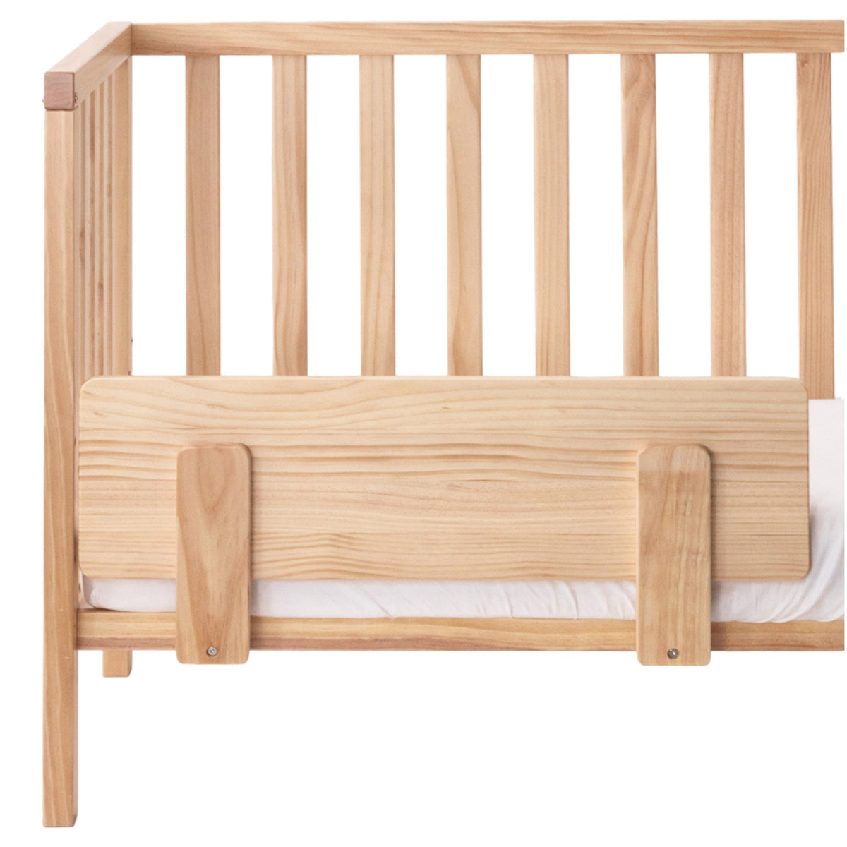 Wooden crib with a safety toddler conversion kit on a white background