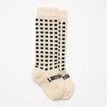 White with black squares knee high socks on a white background