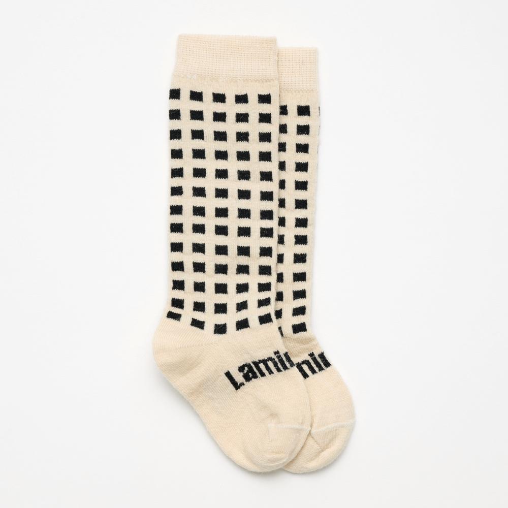 White with black squares knee high socks on a white background