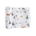 A white cotton muslin swaddle wrap with forest-themed patterns on a white background