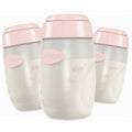 Three Uninom baby bottles with translucent white bodies, pink caps, and pink measurement markings, arranged in a studio shot on a white background.