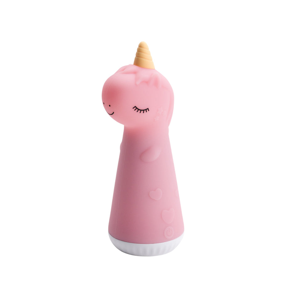 Pink Unicorn shaped silicone torch with yellow horn on a white background