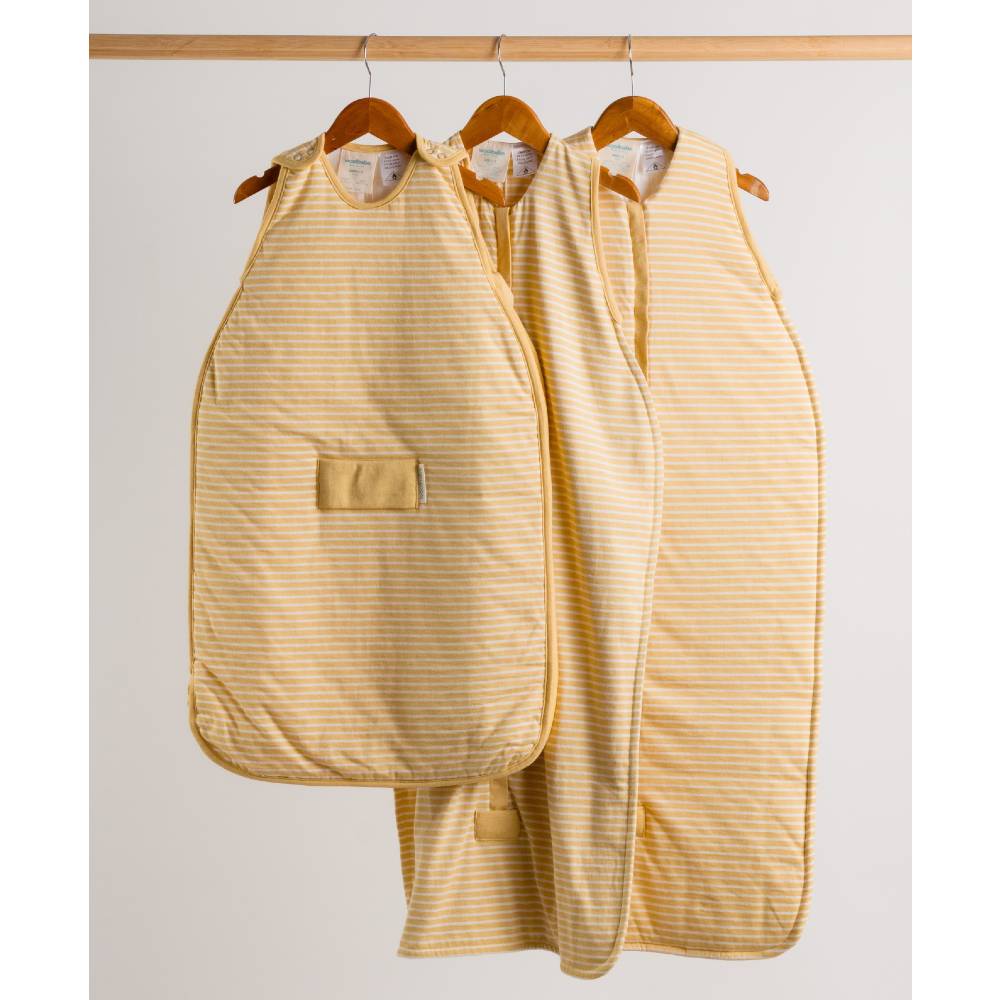 woolbabe buttercup yellow striped baby sleeping bags hanging on wooden hangers against a light gray background.
