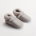 Pair of gray slippers with fuzzy trim on a white background