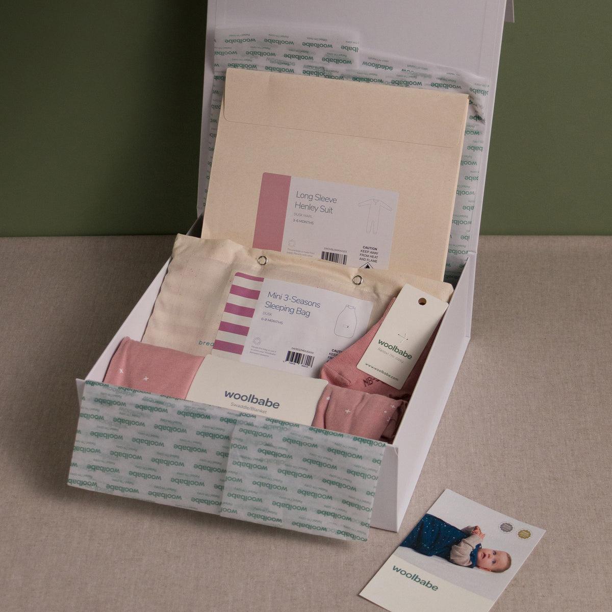 Woolbabe baby product set in a box with a green background