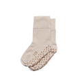 Pair of beige baby and kids socks with textured non-slip sole on a white background