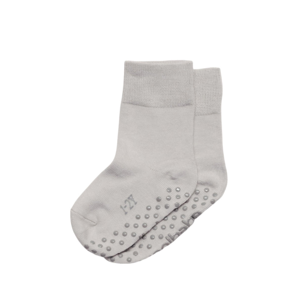 Gray kids socks with non-slip sole on a white background