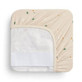 A waterproof fitted sheet shown on a mattress in Daisy Sprinkle pattern