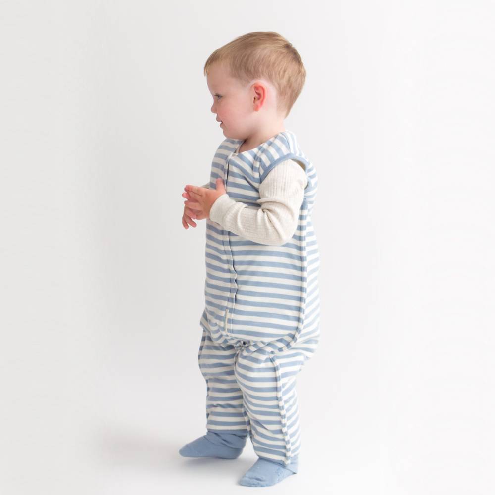 Child wearing a blue and white striped outfit on a plain background