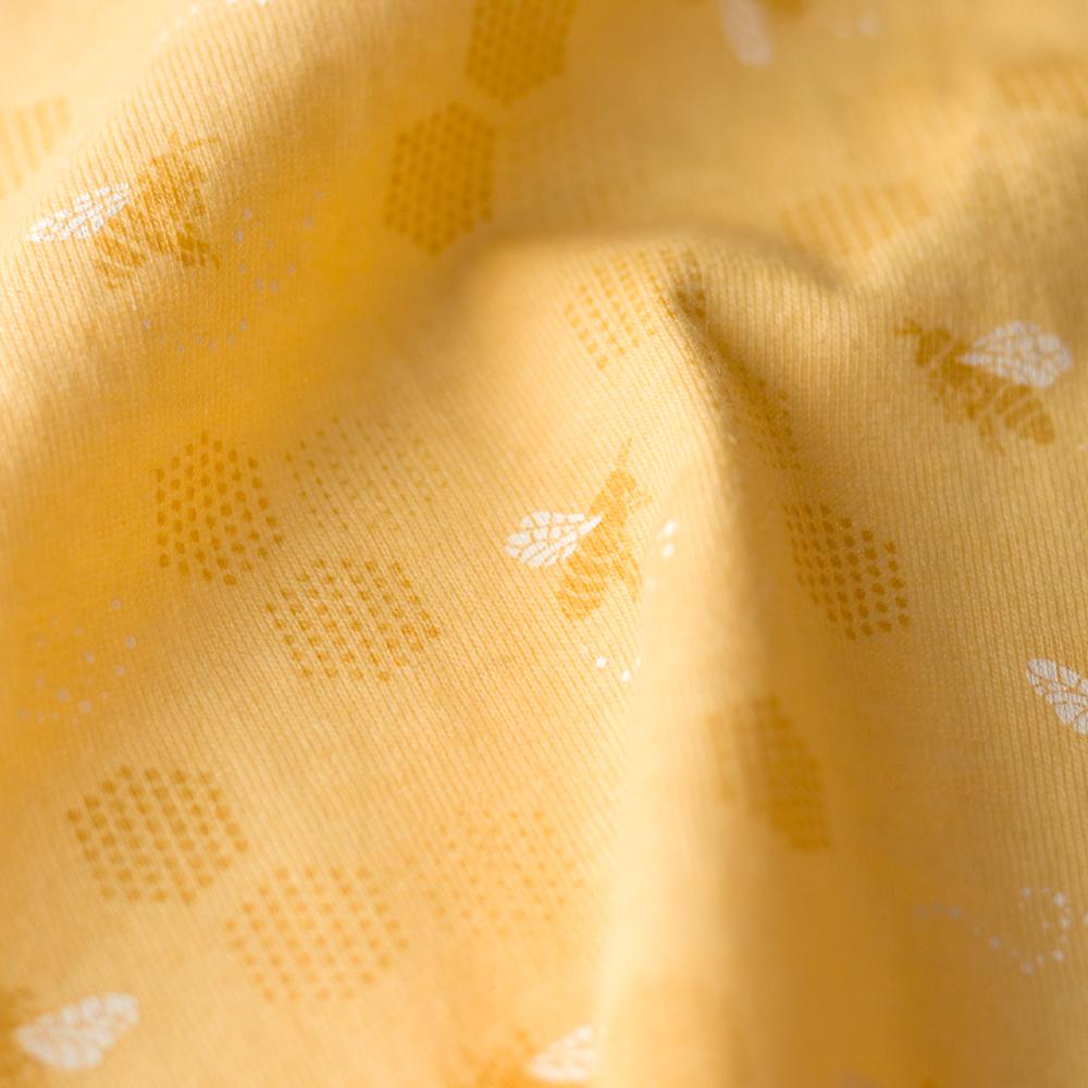Close-up of yellow fabric with subtle pattern